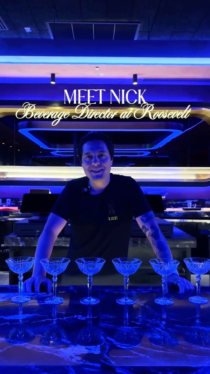 Nick behind the bar with a row of coupe glasses