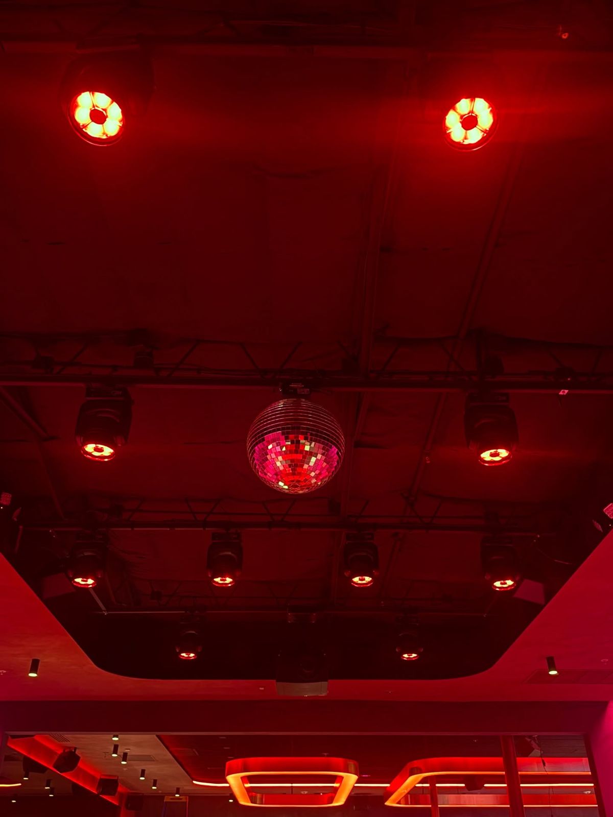 Red lit ceiling with a mirror ball