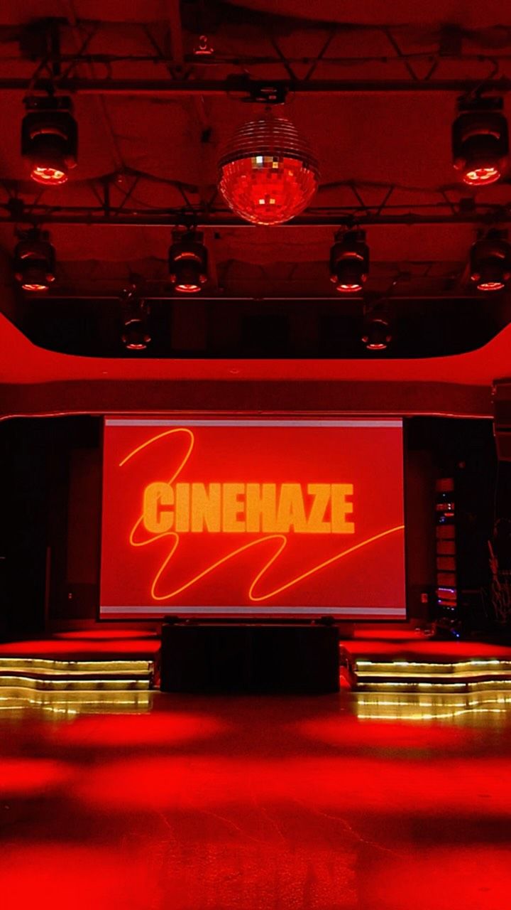 The screening setup glowing red with the Cinehaze logo on screen